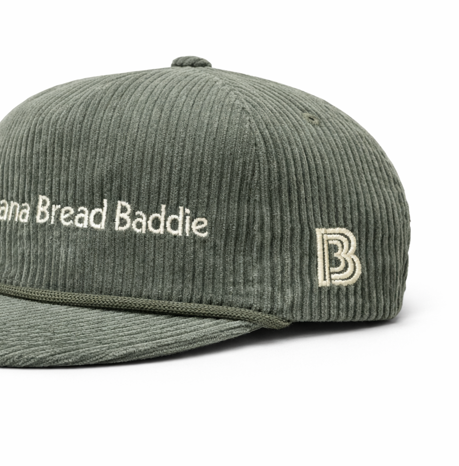 Green corduroy cap with 'Banana Bread Baddie' text on front & vintage B logo on left side panel