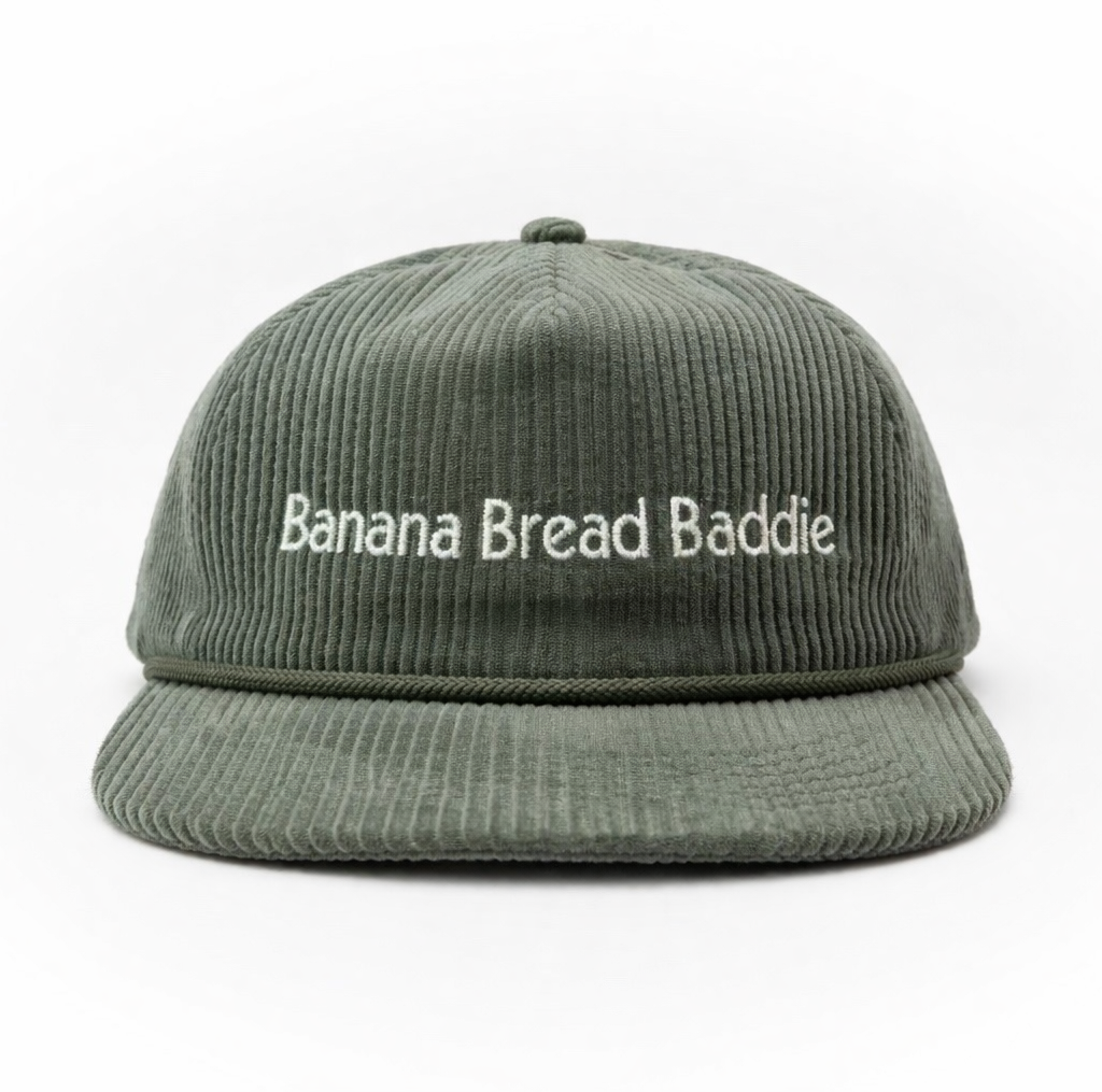 Green corduroy cap with 'Banana Bread Baddie' text on front & vintage B logo on left side panel