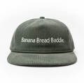 Green corduroy cap with 'Banana Bread Baddie' text on front & vintage B logo on left side panel