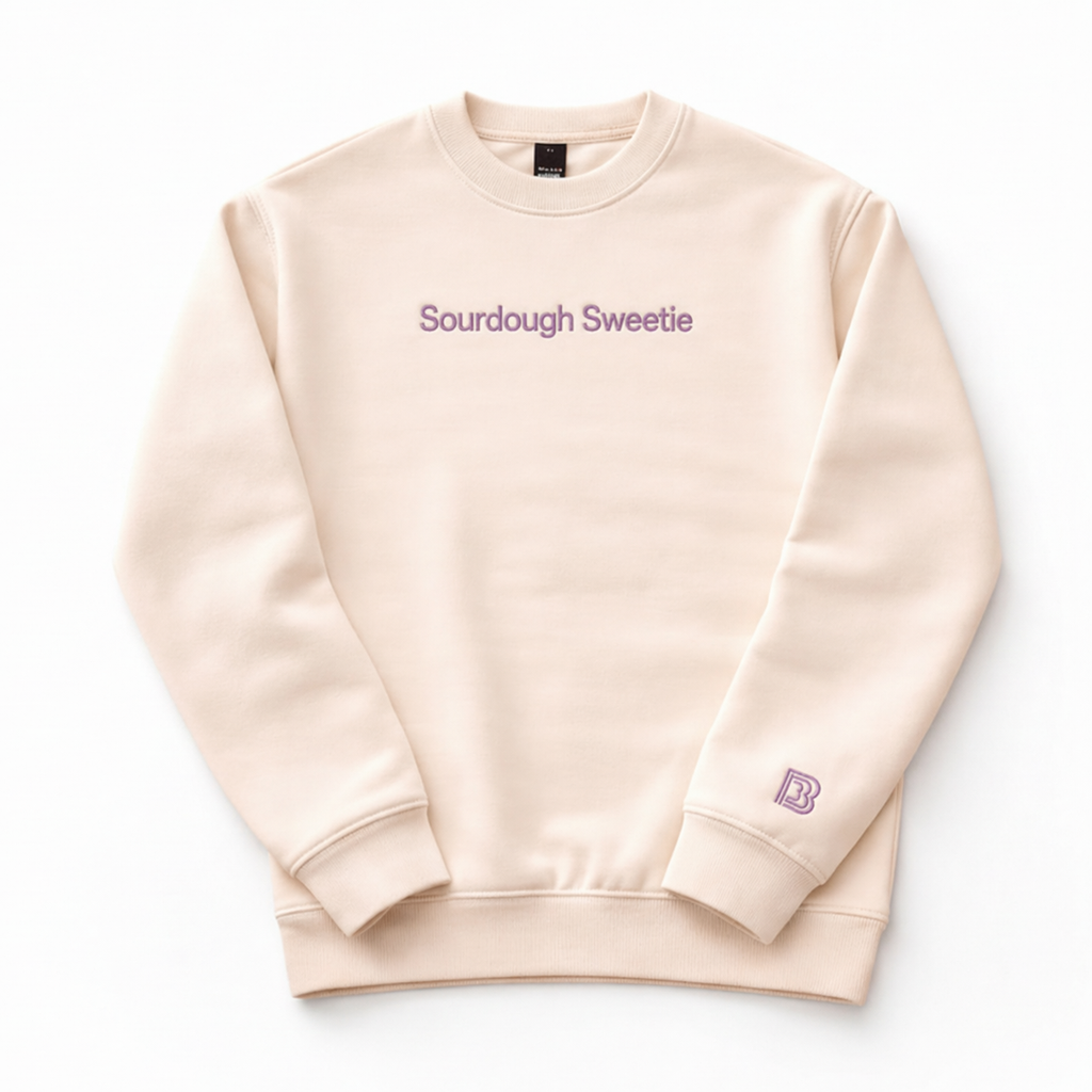 Beige sweatshirt with 'Sourdough Sweetie' text and logo on a white background