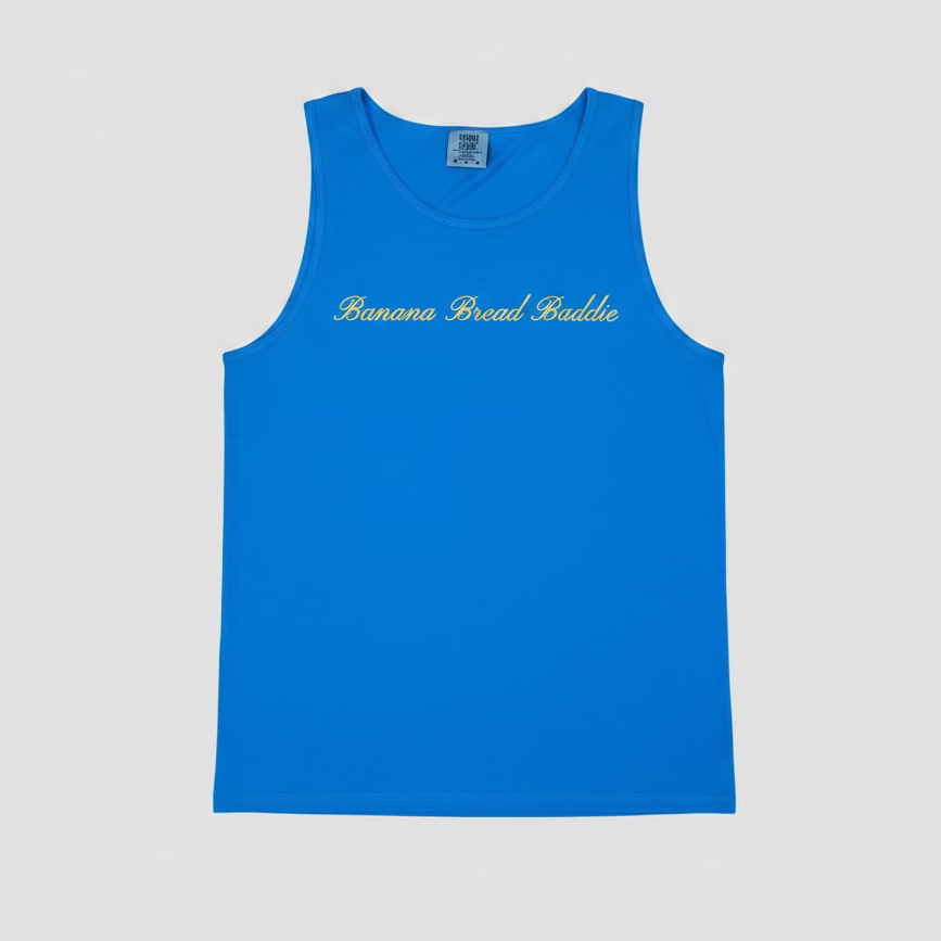 A bright blue sleeveless tank top with 'Banana Bread Buddle' printed in yellow cursive across the chest, displayed flat against a light gray background.