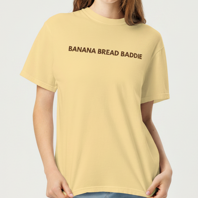 Woman wearing a yellow t-shirt with 'BANANA BREAD BADDIE' text on a white background
