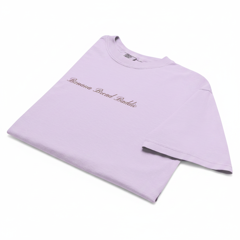 Lavender shirt with 'banana bread baddie' written across chest